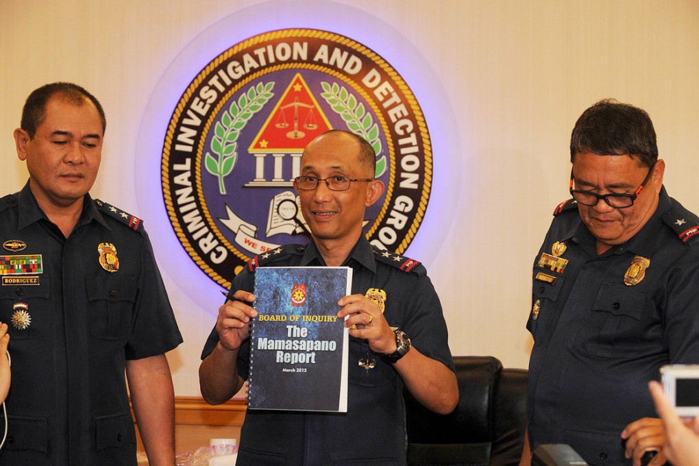 Police Director Benjamin Magalong (centre), flanked by Director Catalino Rodriguez (left) and Chief Superintendent John Sosito, holds a compiled report of the January 25 incident, where 44 police commandoes were killed during a mission against Muslim extremists, at the Philippines National Police headquarters in Manila. Photo: AFP