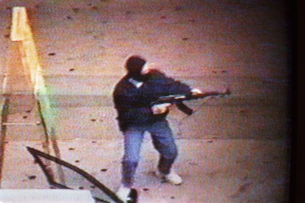 A member of Yip's gang stands guard outside a Nathan Road jewellery store during a 1993 raid. Photo: Eric Li