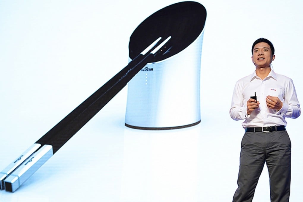 Baidu founder Robin Li Yanhong introduces the smart chopsticks at an even in Beijing in September 2014. Photo: SCMP Pictures