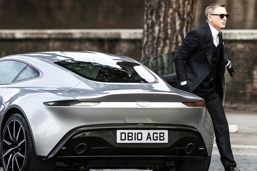 Daniel Craig steps out of his character's Aston Martin sports car while filming a scene for the new James Bond film, "Spectre", in Italy last month. Photo: AP