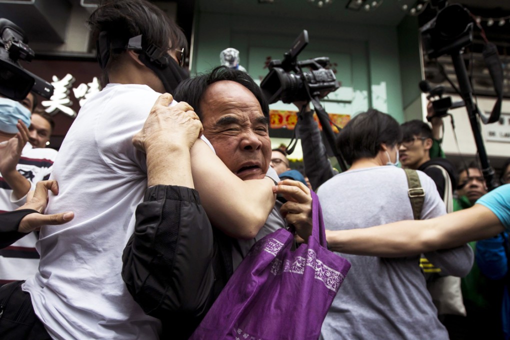 Protesters restrain a man (center) who allegedly beat other fellow protesters during a demonstration against mainland traders at Yuen Long. Photo: Reuters