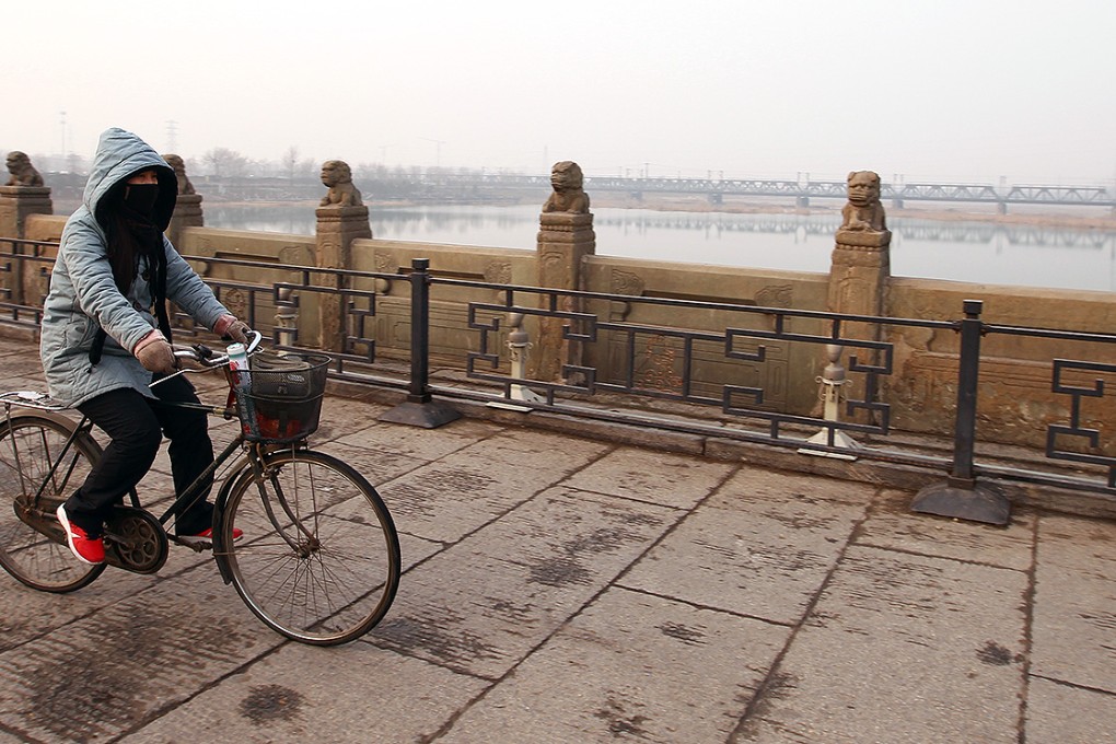 A woman cycles across the Marco Polo Bridge in the capital. Japanese and Chinese forces clashed there in July 1937, marking the start of the Second Sino-Japanese war. Photo: Simon Song
