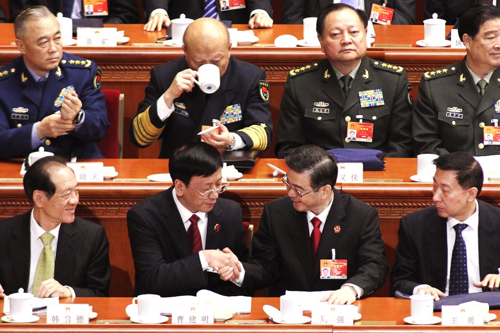 Supreme court president Zhou Qiang (second from right) shakes hands with top prosecutor Cao Jianming yesterday. Photo: Simon Song