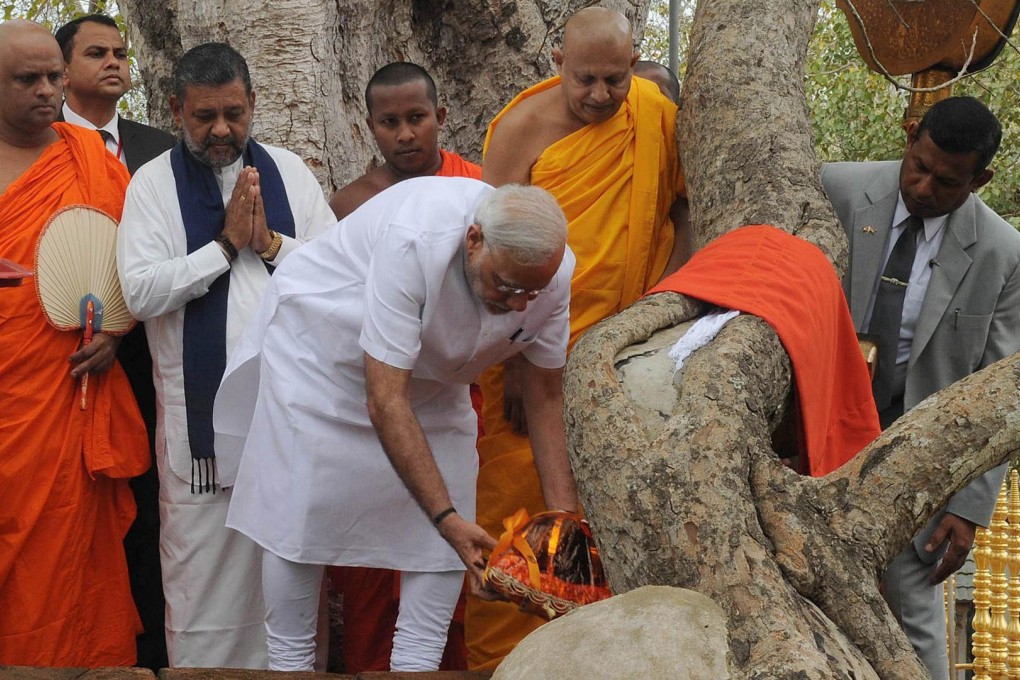 Narendra Modi (centre) offers prayers at the Sri Maha Bodhi tree in Anuradhapura. Photo: AFP