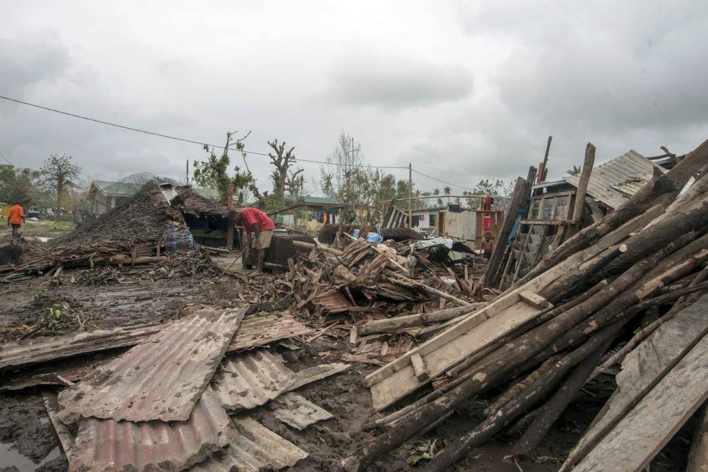 Residents move debris near homes destroyed by Cyclone Pam in Port Vila, the capital city of Vanuatu. With winds of more than 300km/h, Pam razed homes, smashed boats and washed away roads. Photo: Reuters
