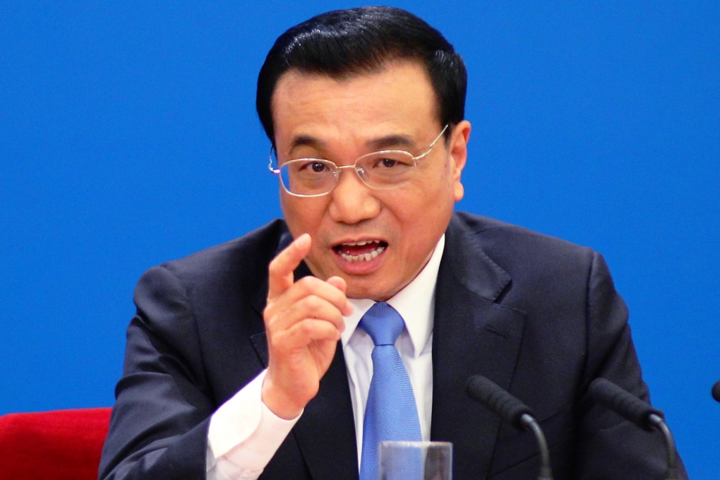 Premier Li Keqiang addresses the media in the Great Hall of the People yesterday, admitting that he sees difficulties ahead for China to meet its economic growth target. Photo: Reuters