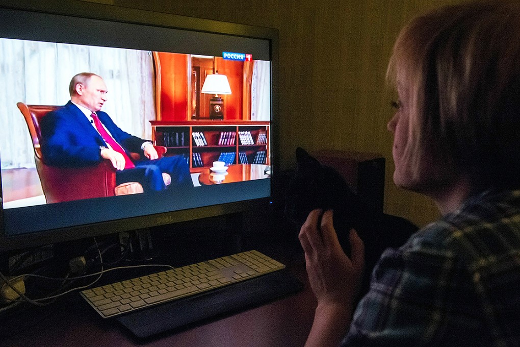 A Moscow resident watches an internet broadcast of the documentary "Homeward Bound". Photo: AFP