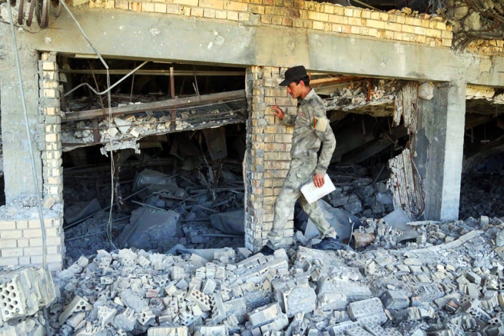 A soldier inspects Hussein's damaged tomb. Photo: AP