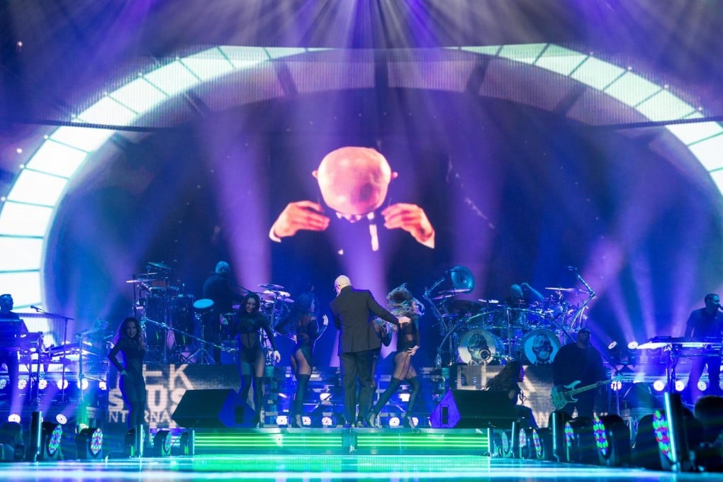 Gone global: Pitbull and his band performing in Chicago last month. Photos: Corbis