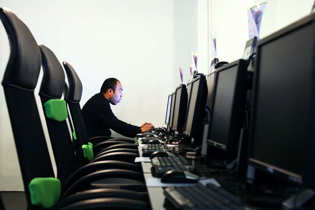 A man uses a computer at an internet cafe in Hong Kong. Photo: May Tse