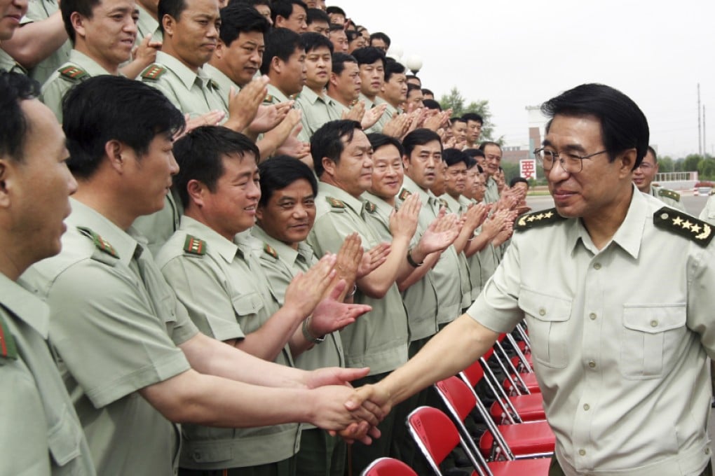 Disgraced former general Xu Caihou, whose death was reported on Sunday, is pictured in 2004 greeting members of China's PLA in Jilin province. Photo: AP