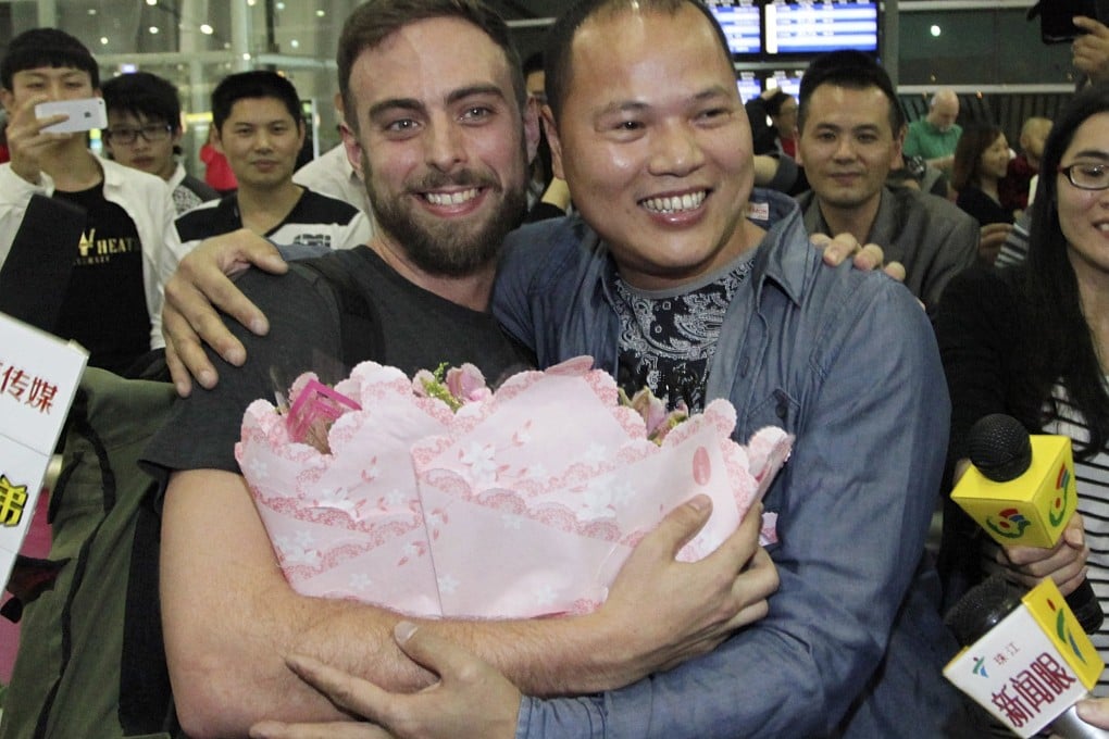 BuzzFeed's Matt Stopera is greeted by 'Brother Orange' at the Jieyang airport. Photo: Reuters