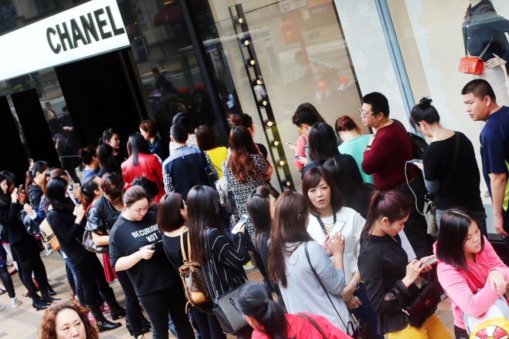 Shoppers queue outside the Chanel store in Tsim Sha Tsui on Wednesday. Photo: David Wong