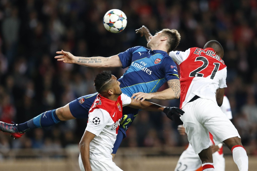 Arsenal's Olivier Giroud vies with Monaco's  Wallace in their  Champions League match  at Louis II stadium in Monaco. Photo: AFP