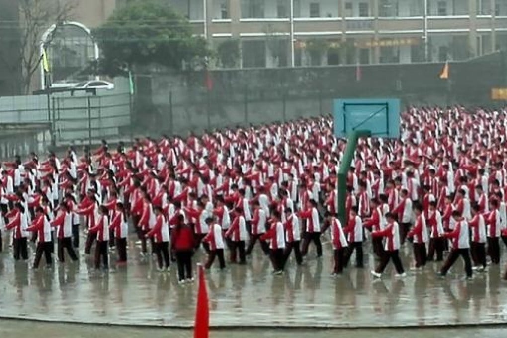 Students at a middle school in Yulin, China, are forced to work out in the rain. Photo: SCMP Pictures