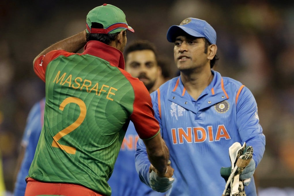 Bangladesh captain Mashrafe Mortaza (left) shakes hands with victorious India captain MS Dhoni after India's 109-run quarter final win over Bangladesh. Photo: Reuters