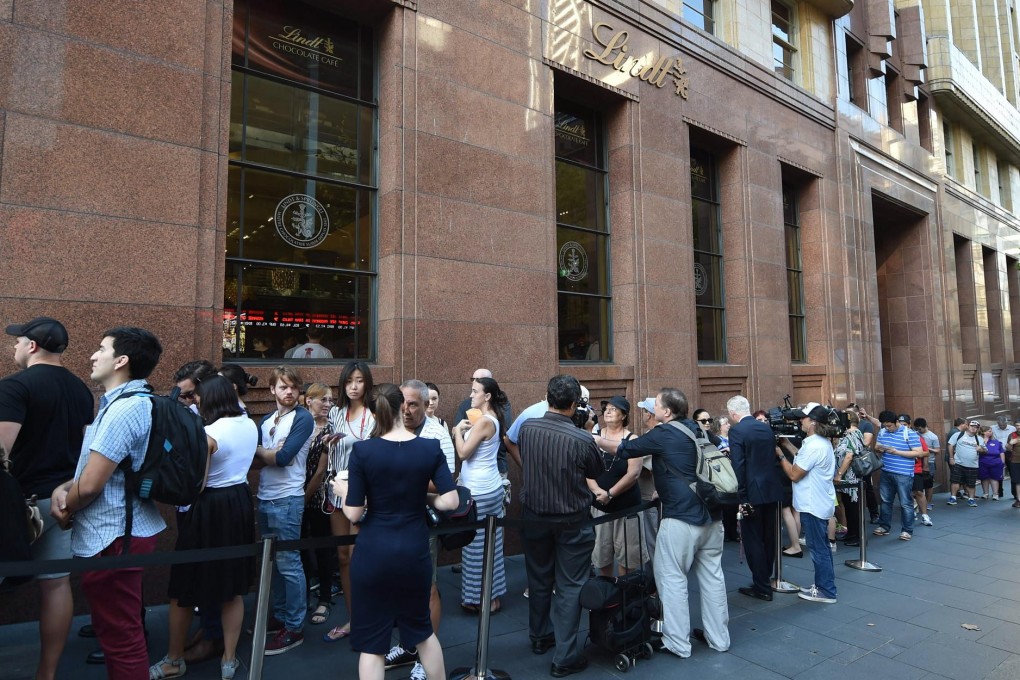 Many members of the public queue outside the Lindt Cafe in Sydney just before it reopened.Photo: AFP