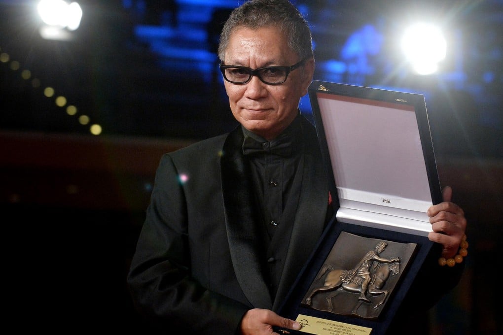 Takashi Miike with his maverick director award from the Rome Film Festival. He adapted his latest films, Over Your Dead Body and As the Gods Will, from a kabuki play and manga, respectively. Photo: AFP