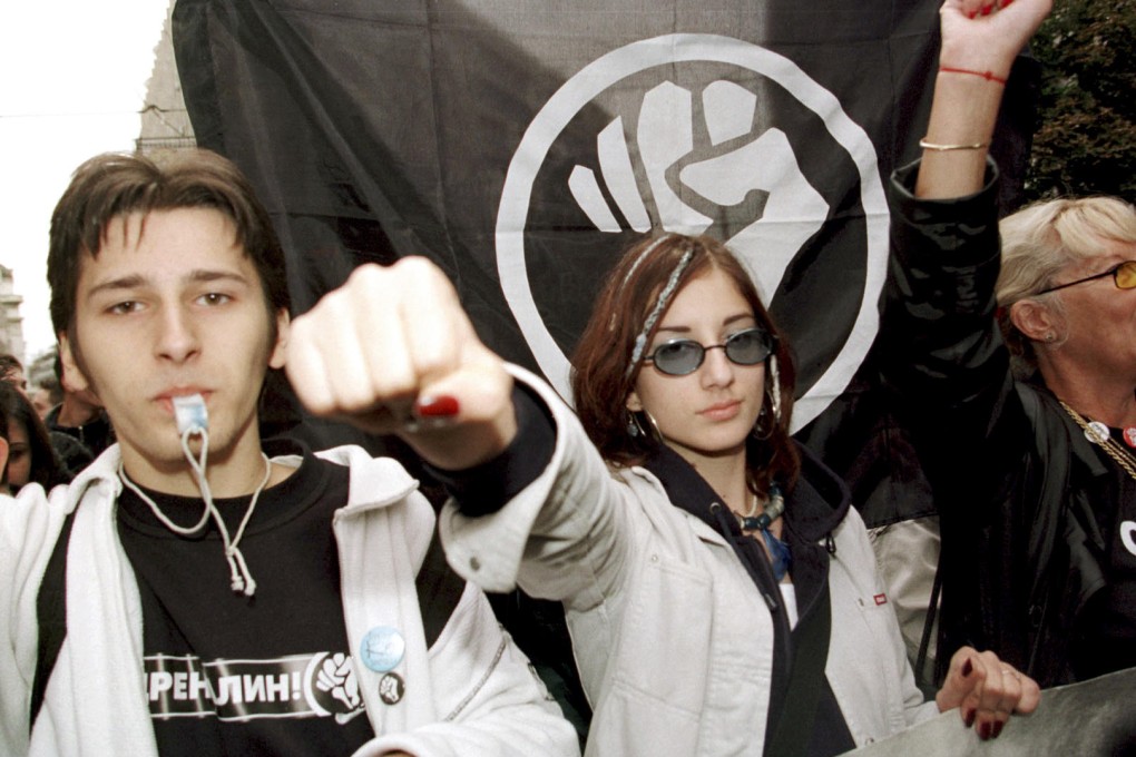 Serbian student protesters march in front of an Optor! banner on their way to president Slobodan Milosevic's residence in October 2000. Photo: Corbis