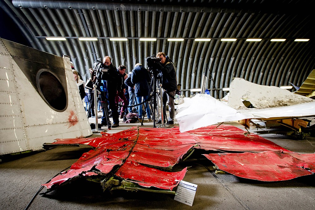 Members of the media film wreckage from the Malaysia Airlines flight MH17 laid out in a hangar at Gilze-Rijen airbase, in the southern Netherlands. Photo: AFP