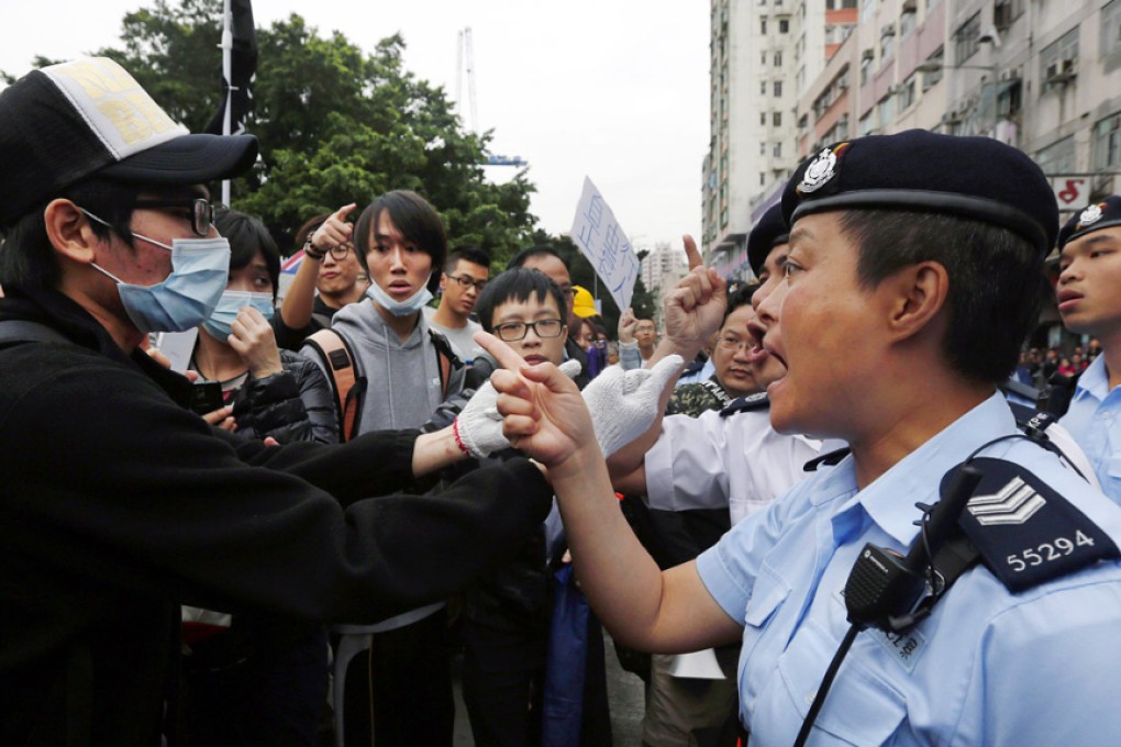 A protester argues with the police during a demonstration against the parallel traders in Yuen Long.  Photo: Reuters