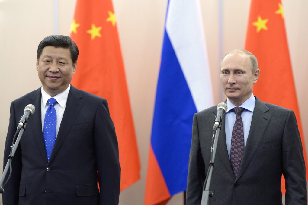 Russian President Vladimir Putin pictured with Xi Jinping during the Chinese head of state's visit to the Winter Olympics in Sochi last year. Photo: EPA