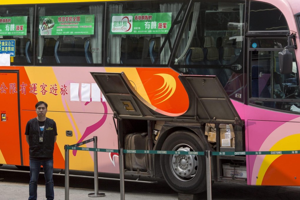 An officer guards a coach used by suspected smugglers. Photo: EPA
