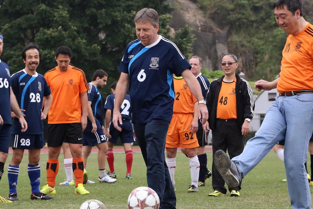 Professors Peter Mathieson (centre) and Joseph Sung Jao-yiu get a kick out of the Vice-Chancellor's Cup Soccer Match. Photo: Felix Wong