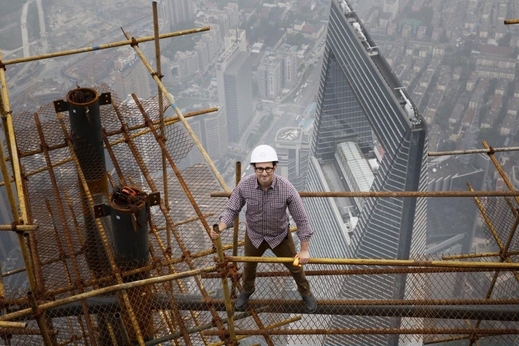 Architect Danny Forster, the host of "How China Works", a three-part series that will air on The Discovery Channel, stands on building scaffolding high above Shanghai. Photo: AFP