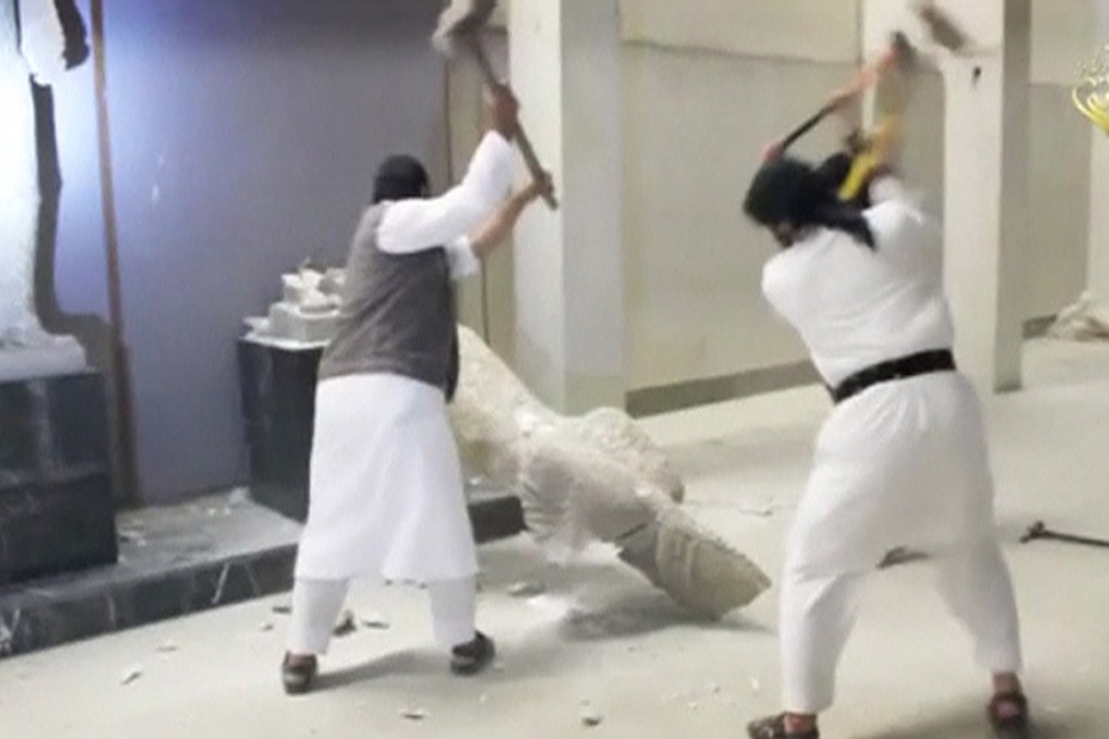 An Islamic State video shows men using sledgehammers on a toppled statue in a museum said to be in Mosul.