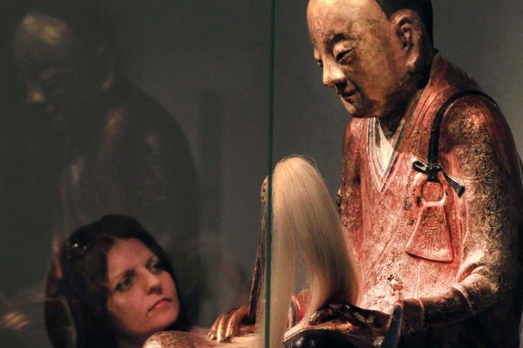 The statue of the Buddha with the mummified remains of a monk inside exhibited at the Mummy World Exhibition in Budapest. The statue has since been returned to its buyer in the Netherlands. Photo: Reuters