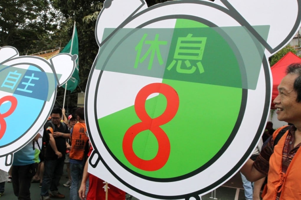 Workers marched on Labour Day last year. A law on standard working hours would affect the entire labour force.