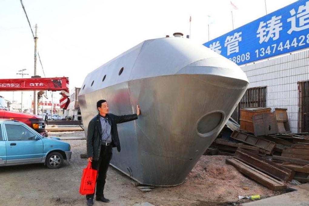 Du Xiutang, 53, with his 300,000 yuan home-made submarine, which he says needs new investment if it is to set sail... and submerge ... as intended. Photo: SCMP Pictures