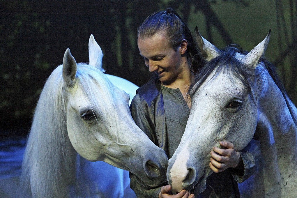 One of the cast with two of the equine stars.