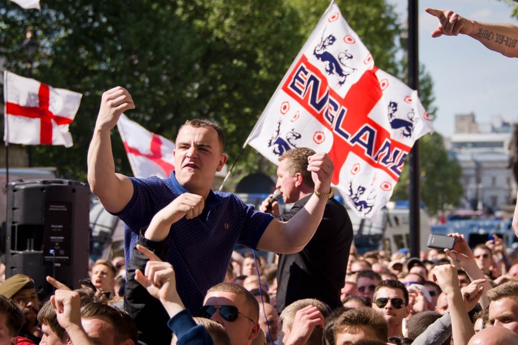 A supporter of the far-right English Defence League (EDL) gestures during a rally in 2013. Afzal Amin is reported to have encouraged the group to announce a new march, which he would allegedly then get cancelled. Photo: AFP