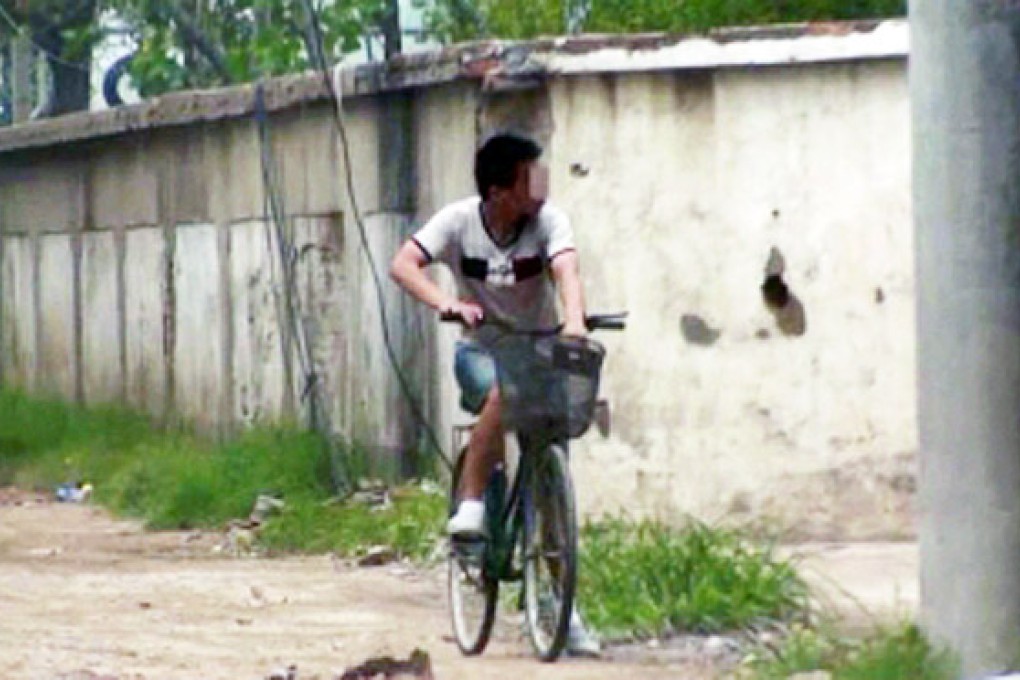 A photograph released by the authorities of the taxi driver allegedly carrying out surveillance on his bike. Photo: Dahe Daily