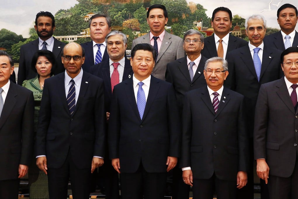 China's President Xi Jinping (front center) poses for photos with guests at the Asian Infrastructure Investment Bank launch ceremony at the Great Hall of the People in Beijing on October 24, 2014. Photo: Reuters