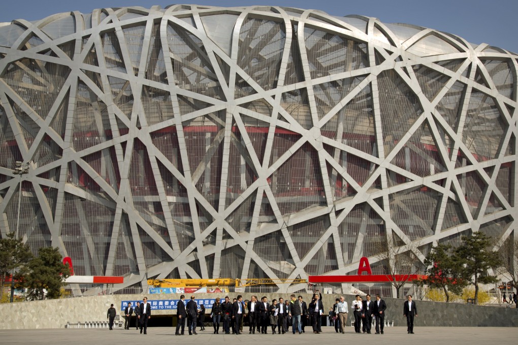 Members of the 2022 Evaluation Commission for the IOC and representatives of Beijing's 2022 Winter Olympics bid committee walk outside Beijing National Stadium. Photo: AP
