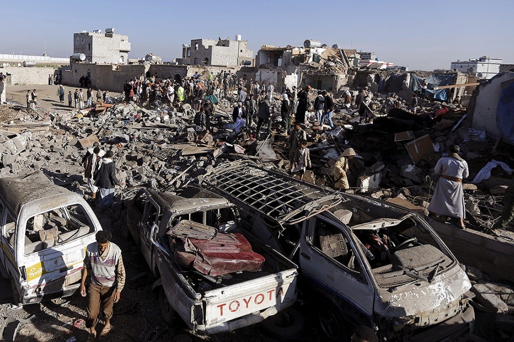 Civil defence workers and people search for survivors under the rubble of houses destroyed by an air strike near Sanaa Airport. Photo: Reuters