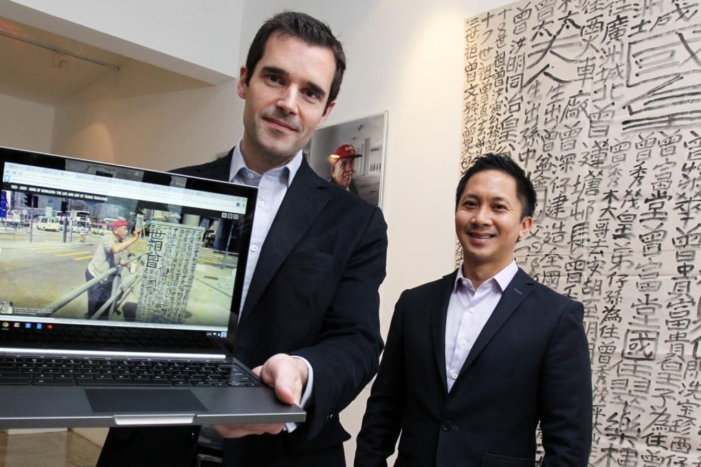 Google Hong Kong managing director Dominic Allon (left) shows off the website with Art Research Institute founder Jehan Chu. Photo: May Tse