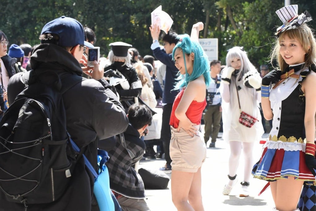 Expo visitors dressed as their favourite anime characters pose for photographers yesterday. Photo: AFP