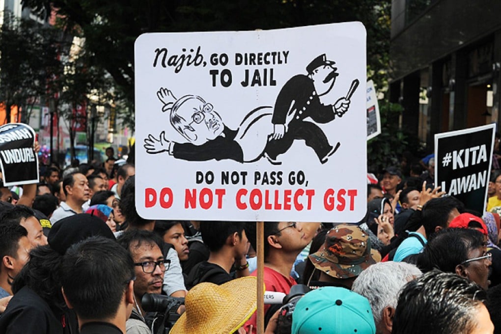 Supporters of Malaysia's opposition leader Anwar Ibrahim hold placards during a protest demanding his release in Kuala Lumpur on Saturday after three of their leading members were arrested. Photo: AFP
