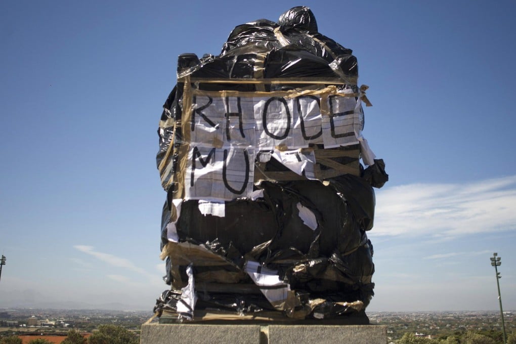 A statue of British colonialist Cecil John Rhodes covered in plastic bags as part of a protest at the University of Cape Town. Photo: AFP