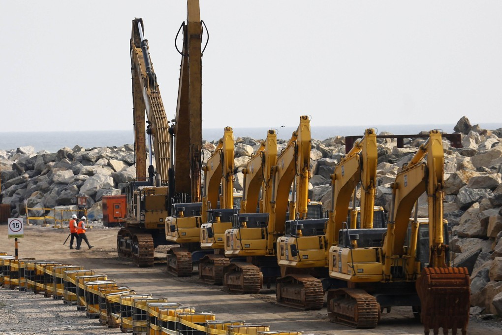 Workers and excavators at the construction site of a Chinese investment project in Colombo Port City. Photo: Reuters