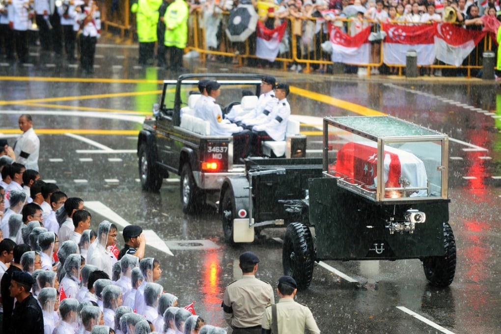 The body of Lee Kuan Yew is transferred atop a gun carriage as they leave Parliament House during a funeral procession. Photo: AFP