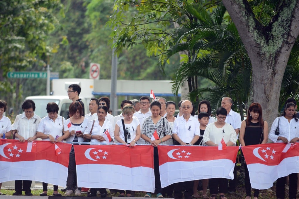 People in Singapore observe a minute's silence on Sunday to mourn the late Lee Kuan Yew. Through competitive elections, Singaporean voters have the power to decide if the PAP should stay in power. Photo: AFP
