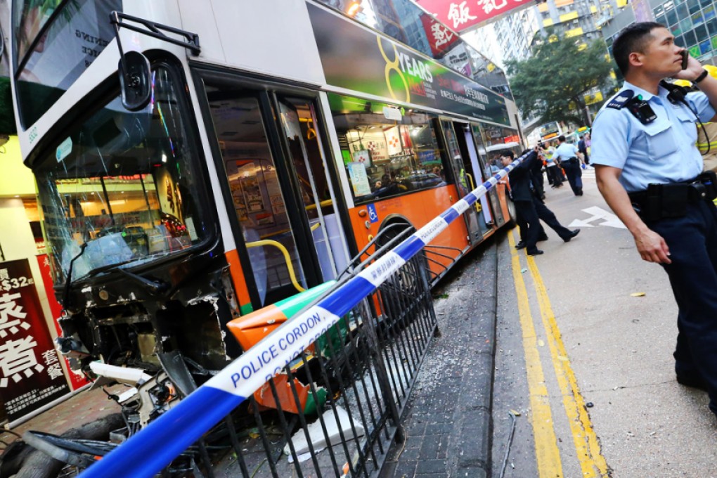 Police cordon off the scene of the accident in Tin Lok Lane. The bus driver told police he felt dizzy before crashing. Photo: David Wong