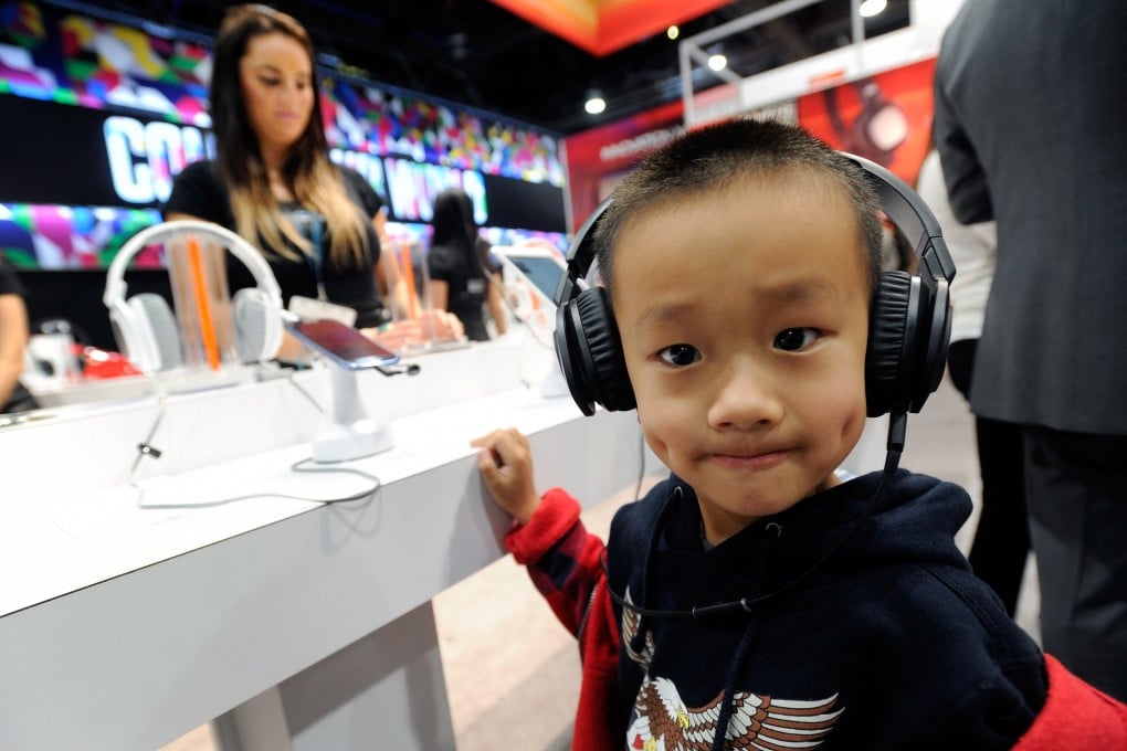 An attendee tries out a pair of headphones at the Consumer Electronics Show in Las Vegas, Nevada. The show will come to Shanghai for the first time this year. Photo: AFP