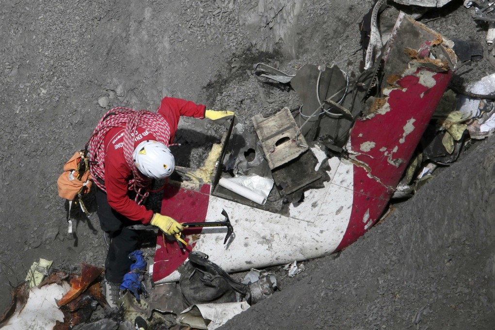 A French rescue worker inspects the remains of the Germanwings Airbus A320 at the site of the crash. Photo: Reuters