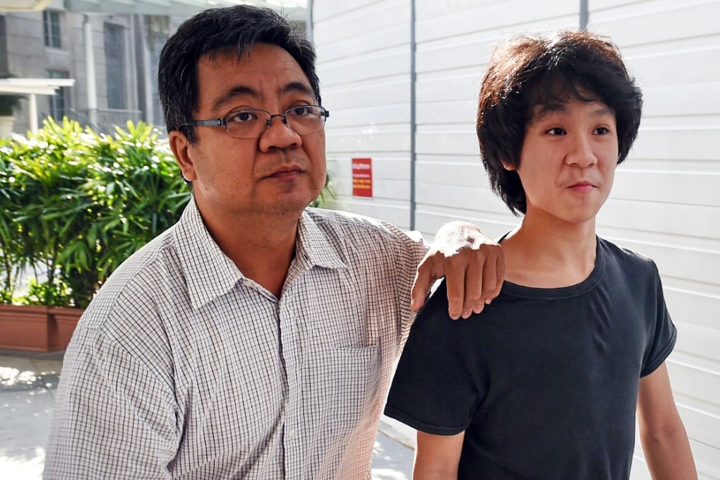 Amos Yee (right) is accompanied to court by his father. The teenager compared Lee Kuan Yew to Jesus Christ, and made disparaging remarks about Christians, the police said. Photo: AFP